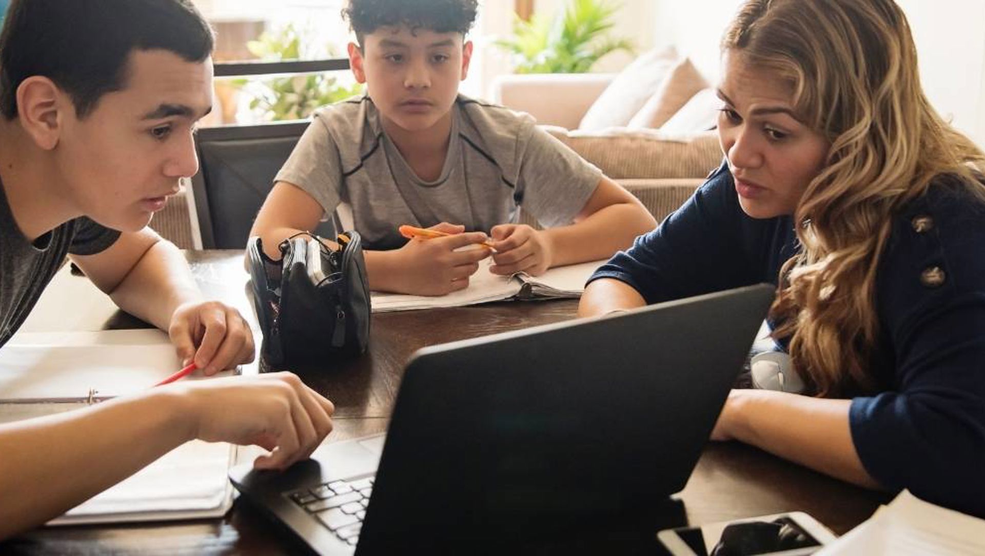 Family discussing something on laptop web