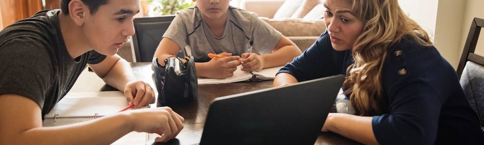 Family discussing something on laptop web