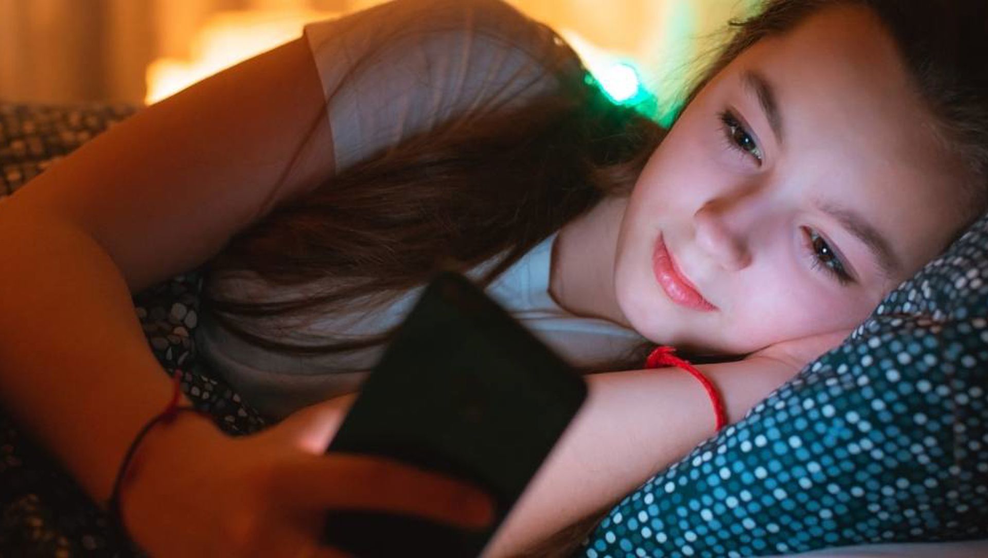 Young girl using mobile at night web