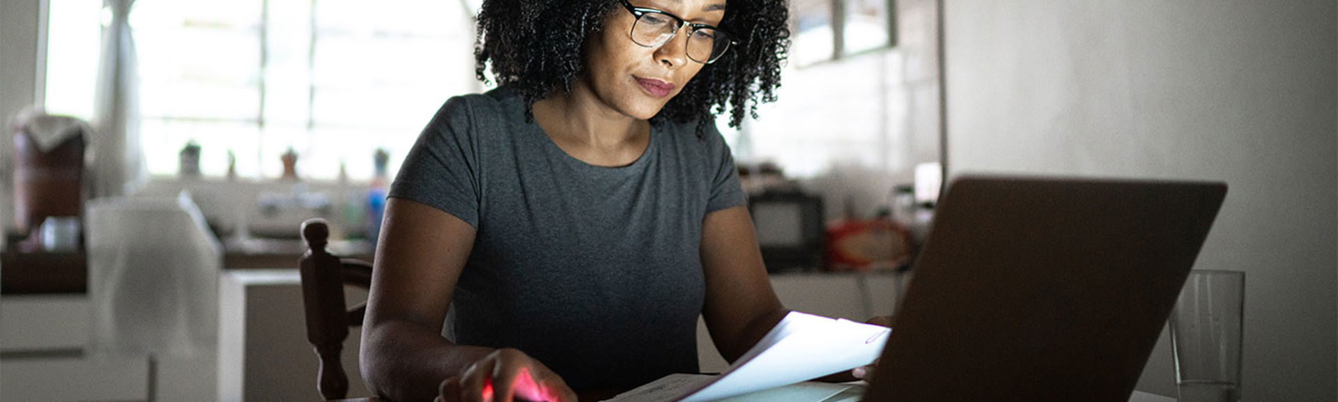 Woman checking her bill in front of a laptop