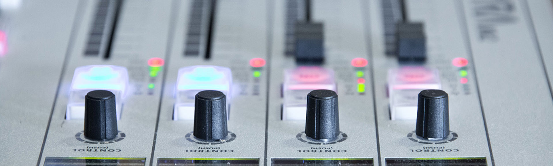 Close up of faders on a broadcast radio desk