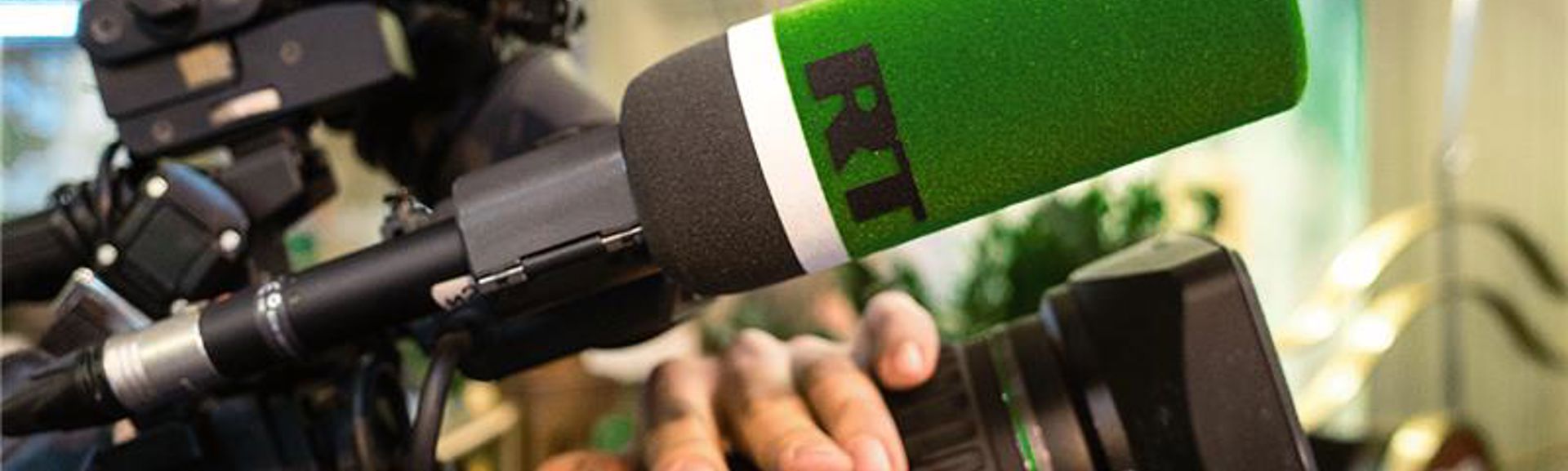 Logo of the TV channel RT (Russia Today) on the microphone of the television camera.