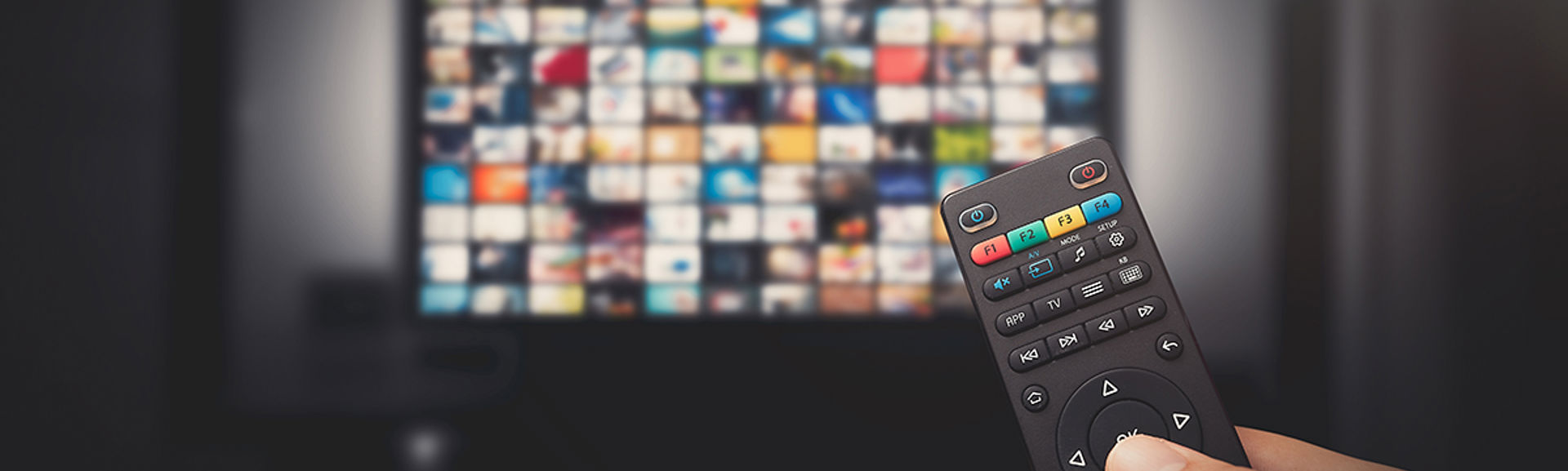 Someone holding a TV remote control